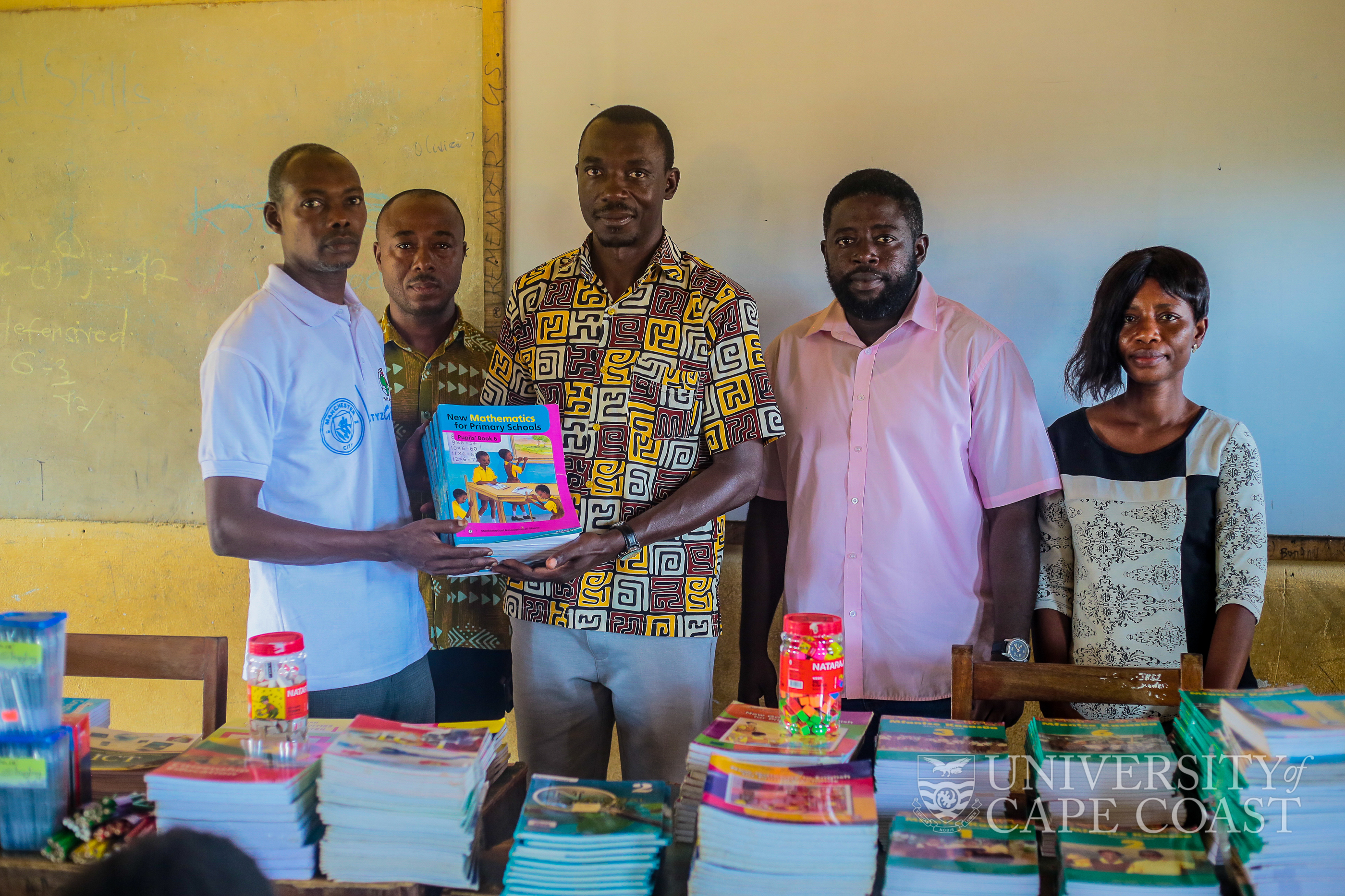 CEO-Takumi Education Foundation, Dr. Benjamin Aboakye making the presentation to head teacher of the School, Mr. Abubakar Tijjani