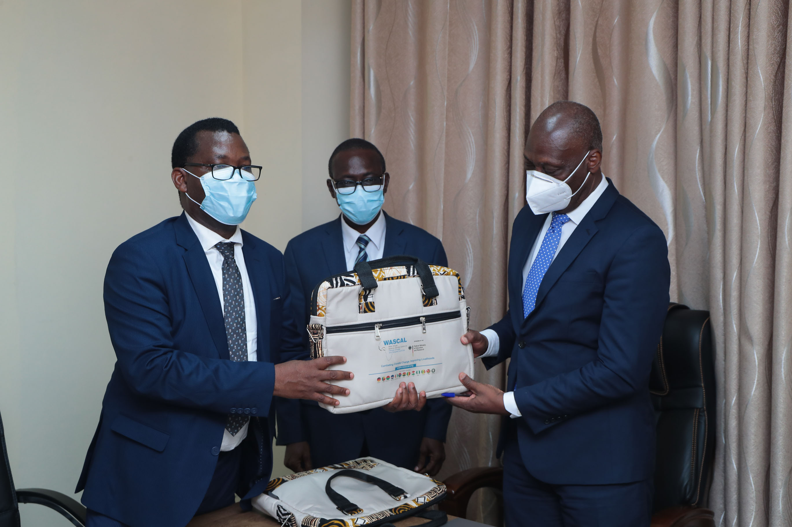 Registrar and Vice-Chancellor receiving a gift from the WASCAL Director of Capacity Building Prof. Daouda Kone.