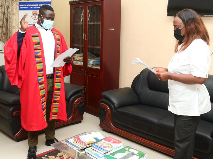 Prof. Darkwah swearing in Mr. Tankong.