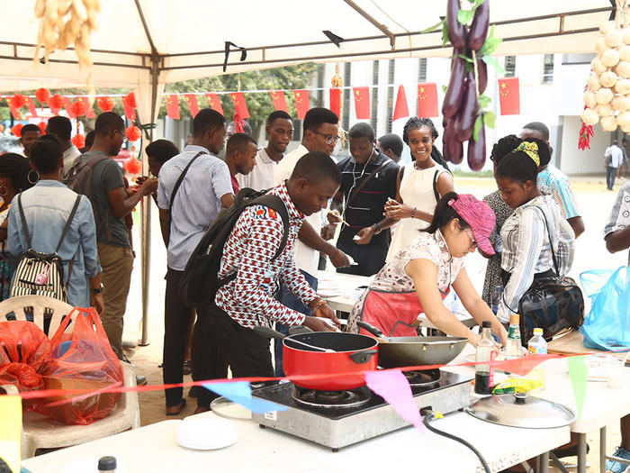 A section of the students observing the cooking of Chinese cuisines A section of the students observing the cooking of Chinese cuisines