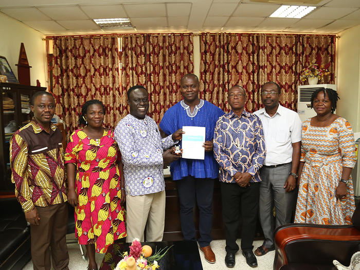 Dr. Julius Eghan Junior presenting his award to the Provost, College of Education Studies Dr. Julius Eghan Junior presenting his award to the Provost, College of Education Studies